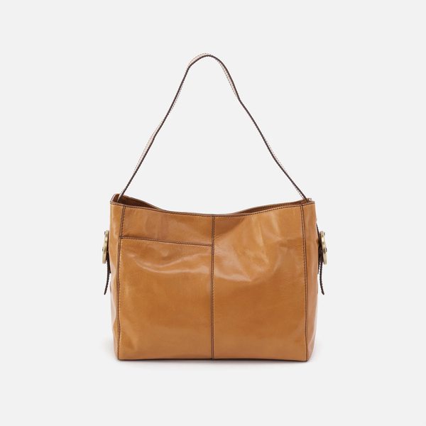 HOBO Render Shoulder Bag in Natural Polished Leather Facing Forward with Antique Brushed Brass Hardware Buckles on the side and a single leather strap.