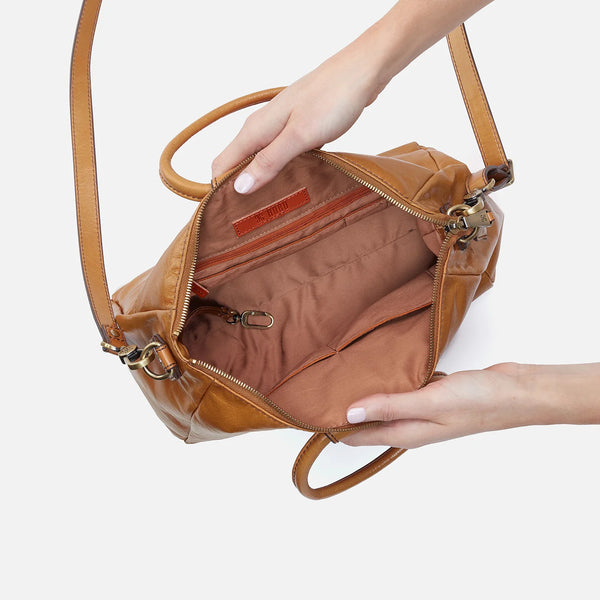 Inside view of HOBO Sheila Medium Satchel Crafted in Natural Polished Leather Visible is a Zipper Pocket and 2 Slip Pockets on One Side and 2 Slip Pockets and a Pen Pocket Opposite.