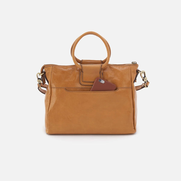 Rear View of HOBO Sheila Medium Satchel Crafted in Natural Polished Leather with Iconic Circular Handle, Removable Shoulder Strap, and Signature Phone Pocket.